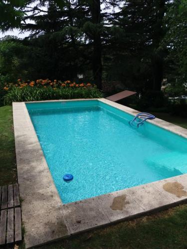 a blue swimming pool with a blue ball in it at Cabaña Gertrudis in Sierra de los Padres