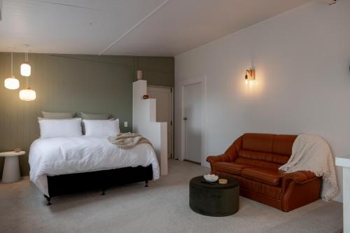 a bedroom with a bed and a couch at The Shed in Cambridge