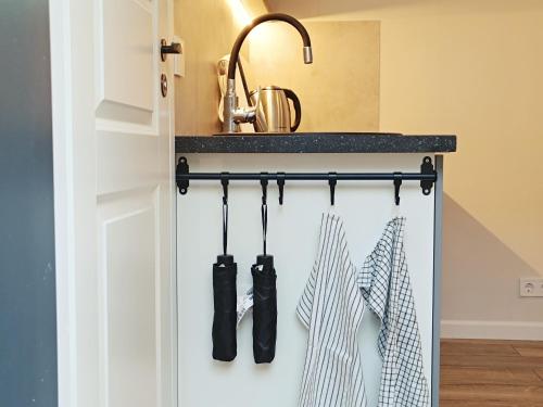a kitchen with utensils hanging from a counter at Tihase tiny house with free bike use in Tallinn