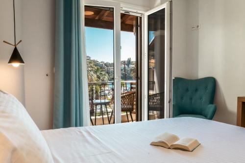 a bedroom with a bed and a view of a balcony at Casa Evanti in Syvota