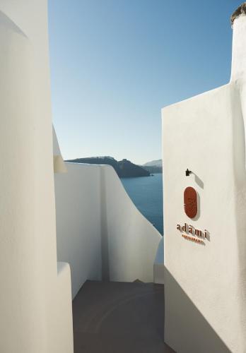 a white bag with a logo on it next to the water at Canaves Ena - Small Luxury Hotels of the World in Oia