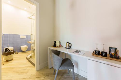 a room with a table and a chair and a bathroom at It's Room Naples in Naples