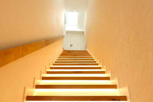 a staircase in a building with a white door at Hotel Particulier Les Rêveries du CLOS derrière St Jean Vignes &Spa Adult Only in Pommard