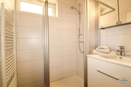 a bathroom with a shower and a sink at Haus Nautic Döse Wohnung 123 in Cuxhaven