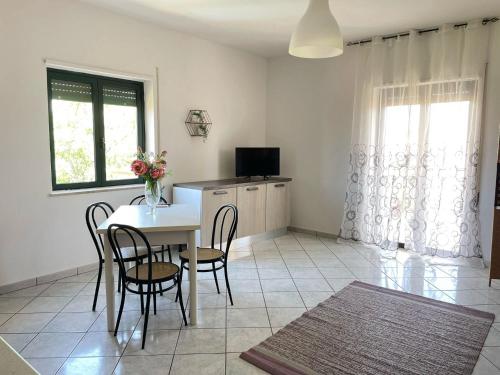 a kitchen and dining room with a table and chairs at Home Le Castella in Le Castella