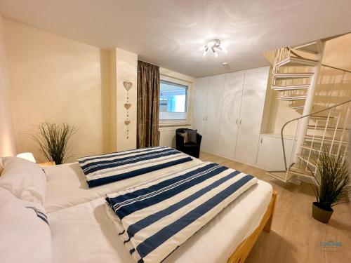 a bedroom with two beds with striped pillows on them at Haus Nautic Döse Wohnung 214 in Cuxhaven