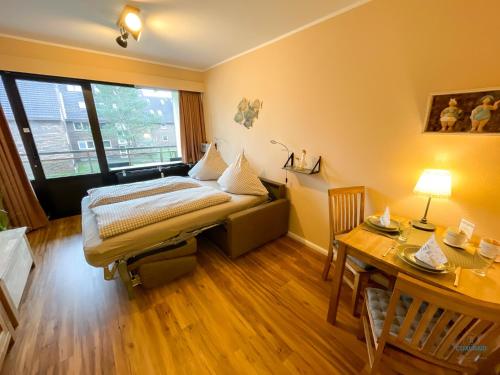 a hospital room with a bed and a table at Whg. 121 Haus Jan am Strand in Cuxhaven