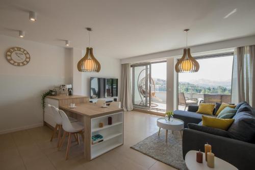 a living room with a couch and a table at Apartview Bukowa III by Rent like home in Wisła