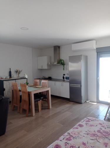 a kitchen and dining room with a table and a refrigerator at Alojamiento de Jorge in Herencia