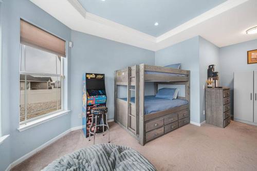 a bedroom with a bed and a video game at Luxury Desert Mountain Retreat 5 BDs 12 ppl Dogs OK near Speedway, Lakes, Snow, Casinos in Fernley