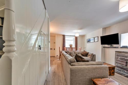 a living room with a couch and a tv at Finest Retreats - Blaen Ddol in Betws-y-coed