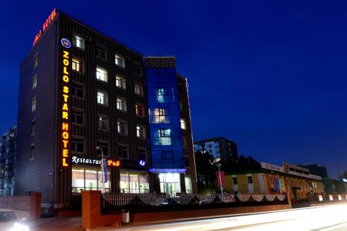 a building on a city street at night at Zolo Hotel in Ulaanbaatar