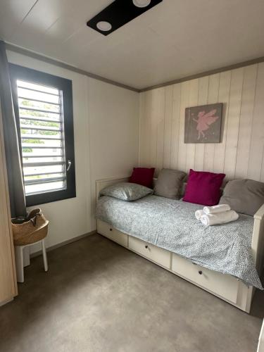 une chambre avec un lit dans une pièce avec une fenêtre dans l'établissement Cottage 79 Landes nature, à Saubrigues