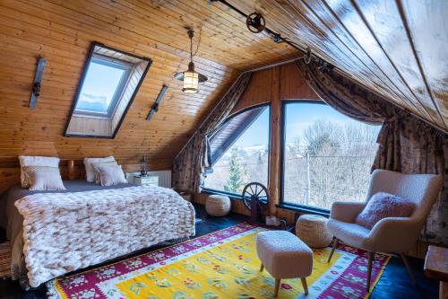 a bedroom with a bed and a large window at Casa Veveritelor in Bran