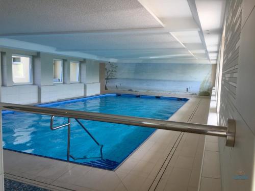 a large swimming pool in a building at Ferienwohnung 223 Haus Nautic in Cuxhaven