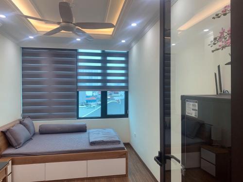a room with a bed and a window with blinds at Sunny Street Hotel in Hanoi