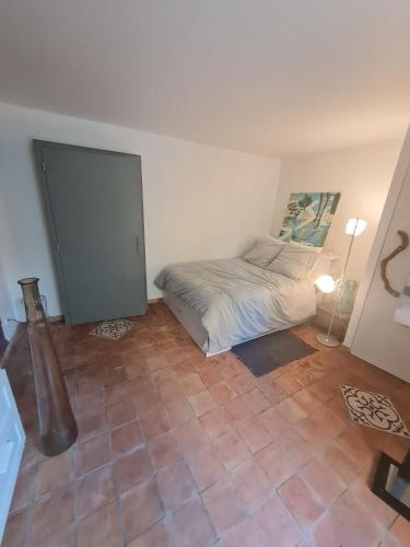 - une chambre avec un lit et une porte dans l'établissement Chambre d'Hôtes, à Volonne