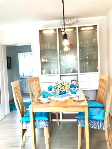 a dining room with a wooden table and chairs at Residenz Thalassa Whg. 3 in Cuxhaven