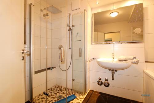 ein Badezimmer mit Dusche und Waschbecken in der Unterkunft Residenz Hohe Lith Wohnung 04 01 in Cuxhaven