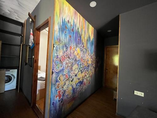 a colorful painting on the wall of a hallway at HOTEL Dadu in Batumi