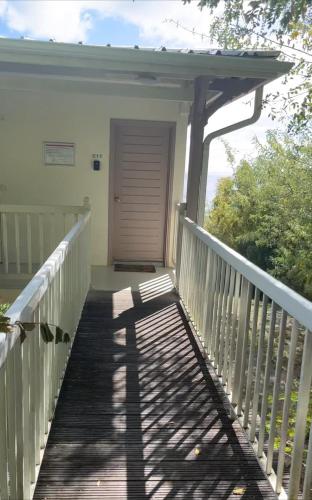 a porch of a house with a wooden walkway at Dayana Diamond in Le Diamant