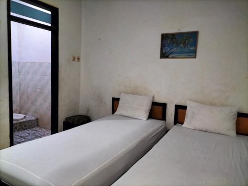 Postel nebo postele na pokoji v ubytování Hotel Kudus Permata
