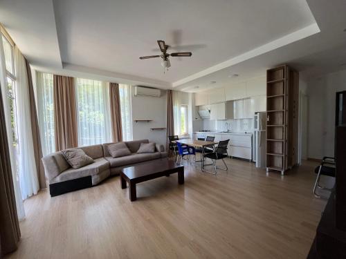 a living room with a couch and a table at HOTEL Dadu in Batumi