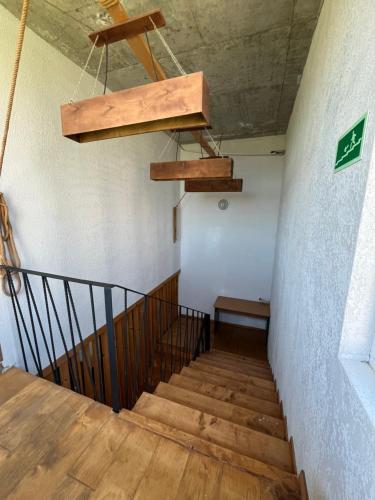 a staircase in a building with wooden stairs and a chandelier at HOTEL Dadu in Batumi