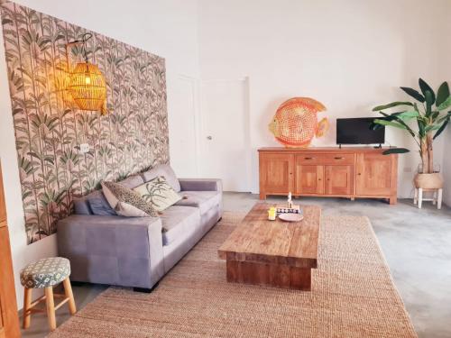 a living room with a couch and a coffee table at 13 Palm Tree in Kralendijk