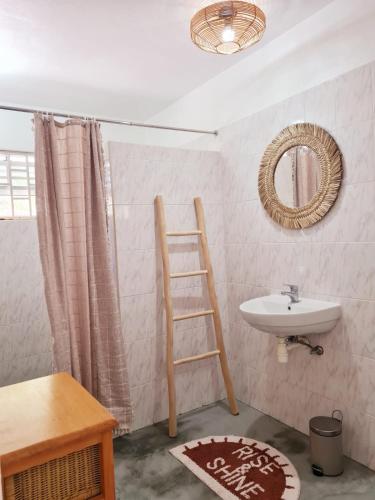 a bathroom with a ladder and a sink and a mirror at 13 Palm Tree in Kralendijk