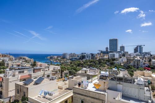 a view of the city from the roof of a building at 1 Bedroom Penthouse Retreat for Couples & Families with Large Rooftop Terrace and Pool in Pembroke 