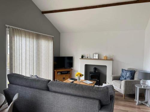 a living room with a couch and a table at Seaside Escape Chalet in Bridlington south shore in Bridlington