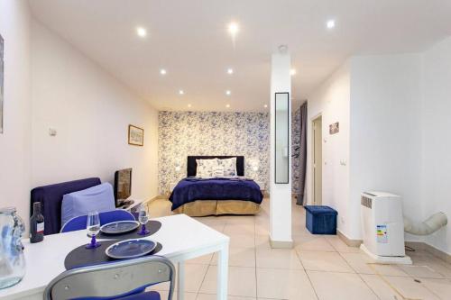 a bedroom with a bed and a white table and chairs at Alfama IV in Lisbon