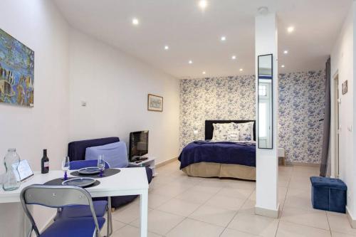 a bedroom with a bed and a table and chairs at Alfama IV in Lisbon
