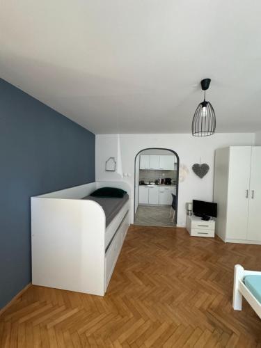 a bedroom with a white bed and a mirror at Apartmani Luciano in Novalja