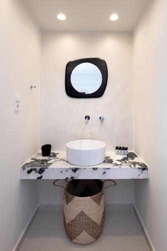 a bathroom with a sink and a mirror at La Stella Suites in Platanes