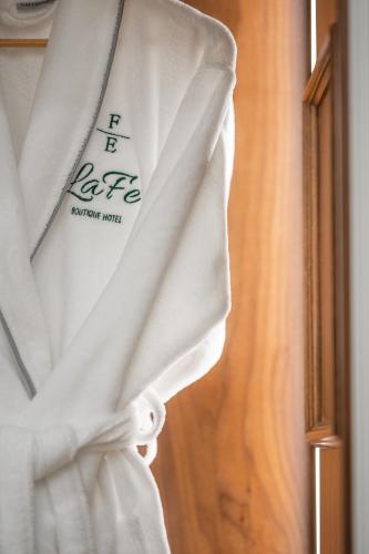 a white curtain with a sign on it at La Fe Boutique Hotel Sarande in Sarandë