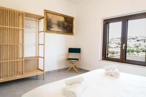 Ένα ή περισσότερα κρεβάτια σε δωμάτιο στο Tenute Nynfà