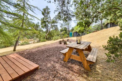 a picnic table and benches in a park at Yosemite Wellbeing Retreat on 5 Acres with Mtn Views in Ahwahnee