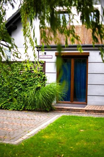 a house with a door with a blue curtain at SCANDINAVIA House - dom z jacuzzi in Zator