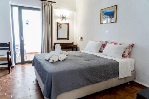 a bedroom with a bed with a towel on it at Hotel Malia Holidays in Malia