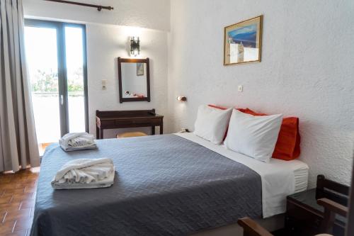 a hotel room with a bed with two towels on it at Hotel Malia Holidays in Malia