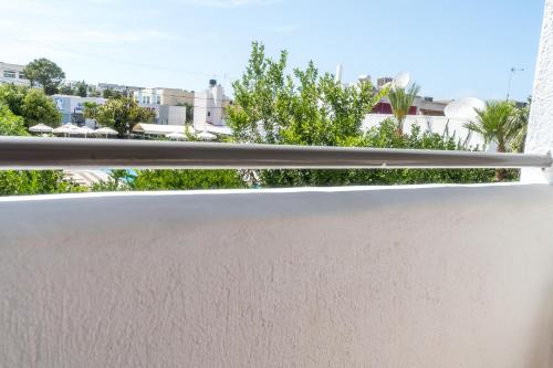 a white railing on a balcony with trees at Hotel Malia Holidays in Malia
