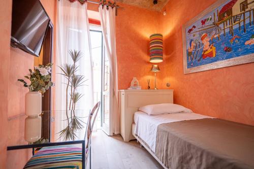a bedroom with orange walls and a bed and a window at La Lisca in Termoli