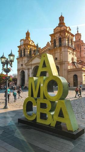 a large metal sign in front of a building at Morada Hostel & Bar in Cordoba