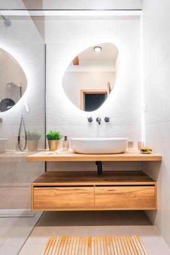 a bathroom with a sink and a mirror at Apartmány Marienhof in Znojmo