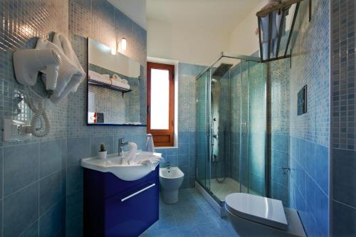 a bathroom with a sink and a toilet and a shower at B&B Suite 123 in Battipaglia