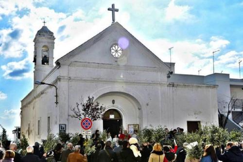 a crowd of people standing outside of a church at Blue Sea Apartment in Torre Canne