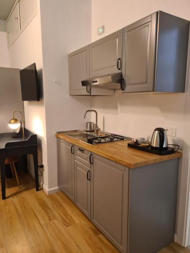 a kitchen with gray cabinets and a counter top at Casa LoRè in Torre Annunziata