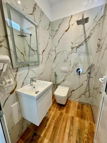 a bathroom with a sink and a toilet at Hotel Balili in Vlorë